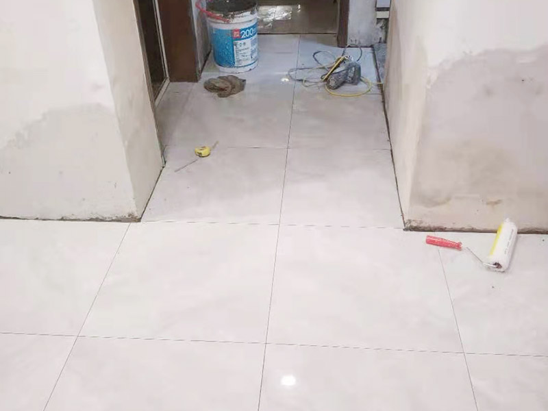 客廳地磚鋪貼:鋪貼前應(yīng)用水泥砂漿找地面或墻面，并按磚體尺寸劃好線，劃線時(shí)需預(yù)留3－5mm的灰縫，以防粘結(jié)物與磚體膨脹系數(shù)不一致而導(dǎo)致不良后果產(chǎn)生。 瓷磚受熱或者冬天遇冷會存在一定熱脹冷縮，同時(shí)粘貼瓷磚的水泥沙土也會隨著溫度和濕度的變化出現(xiàn)一定膨脹收縮，瓷磚間不留縫隙很容易導(dǎo)致瓷磚起拱裂開。瓷磚邊緣存在一定誤差，每塊瓷磚不能保證完全的平整，特別是裝修現(xiàn)場切割瓷磚容易出現(xiàn)誤差，留縫能保持整體整齊劃一。 