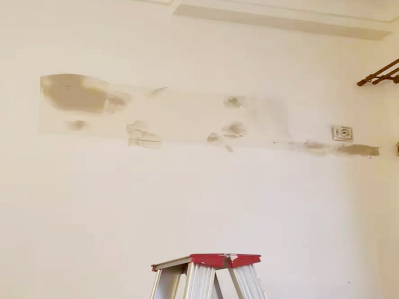 墻面刷新烤燈處理：施工前用塑料保護膜將室內(nèi)的地板覆蓋、家居包裹、電源插座覆蓋；并用膠帶貼牢。對基層原有涂層應(yīng)視不同情況區(qū)別對待：疏松、起殼、脆裂的舊涂層應(yīng)將其鏟除;粘附牢固的舊涂層用砂紙打毛;不耐水的涂層應(yīng)全部鏟除。清除基層表面塵土和其它粘附物。較大的凹陷應(yīng)用聚合物水泥砂漿抹平。并待其干燥。較小的孔洞、裂縫用水泥乳膠膩子修補。 墻面泛堿起霜時用硫酸鋅溶液或稀鹽酸溶液刷洗，油污用洗滌劑清洗，最后再用清水洗凈。